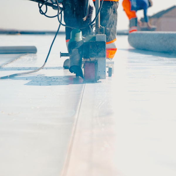 roofer cutting pvc roofing material