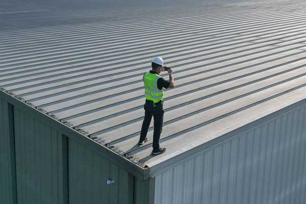 roofer taking a picture of a metal roof
